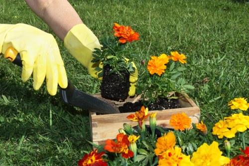 Group of gardeners in PPE preparing equipment before work
